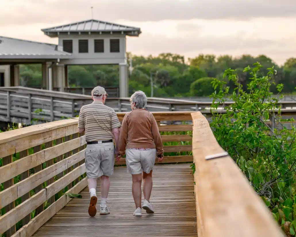 Senior couple walking on a wooden bridge