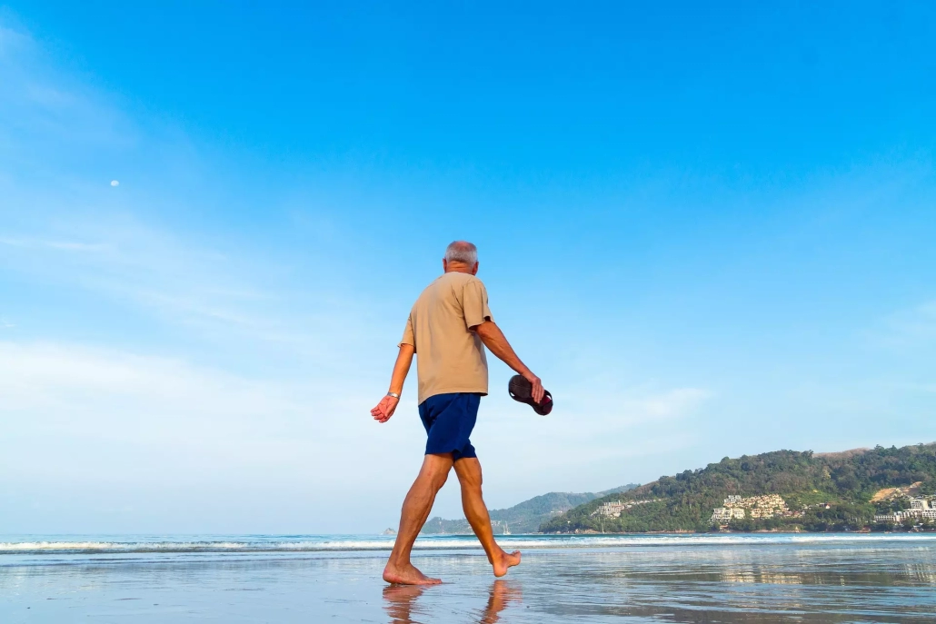 Senior man walking on the seashore alone