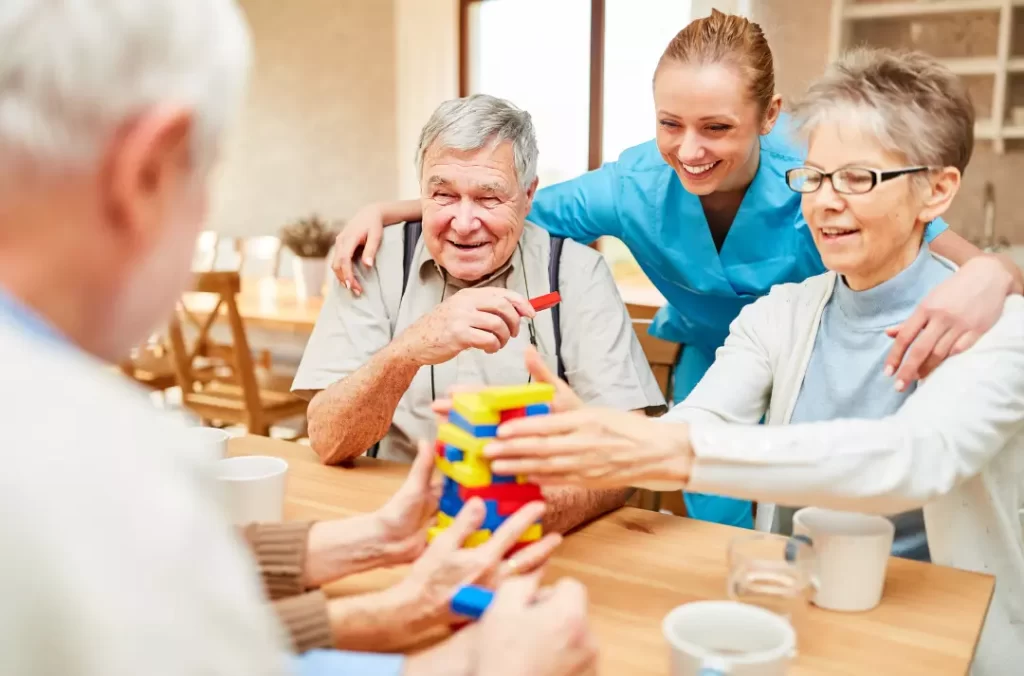 A carer and elderly people having fun together