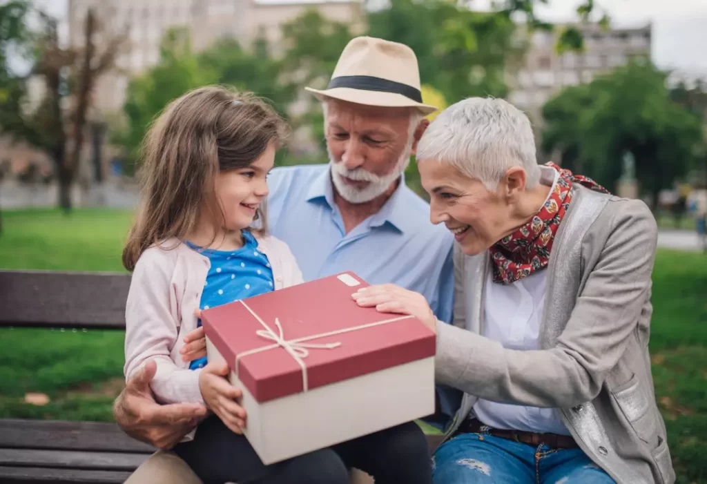 Grandparents gifting their grand daughter