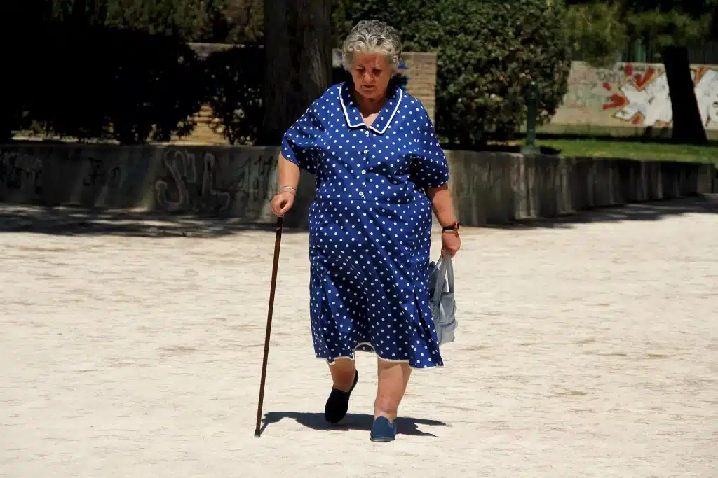 Old woman walking with a cane