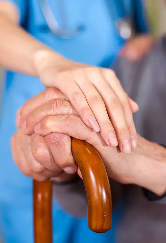 A carer holding an old persons hands