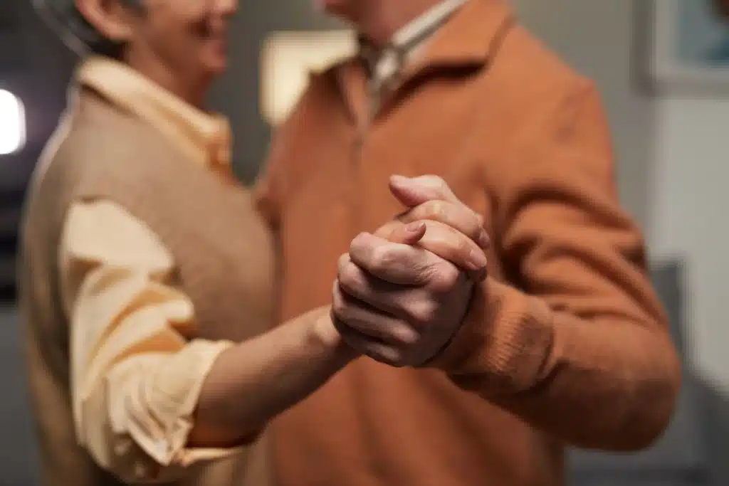 Elderly couple holding each others hands