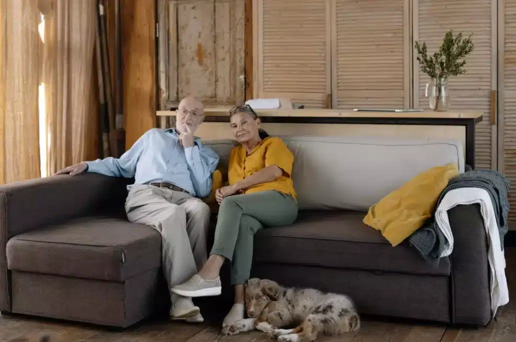 Old couple sitting on a brown sofa