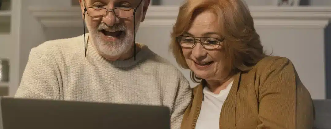 Senior couple using a laptop to research about the aged care sector in Australia.