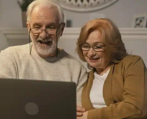 Senior couple using a laptop to research about the aged care sector in Australia.