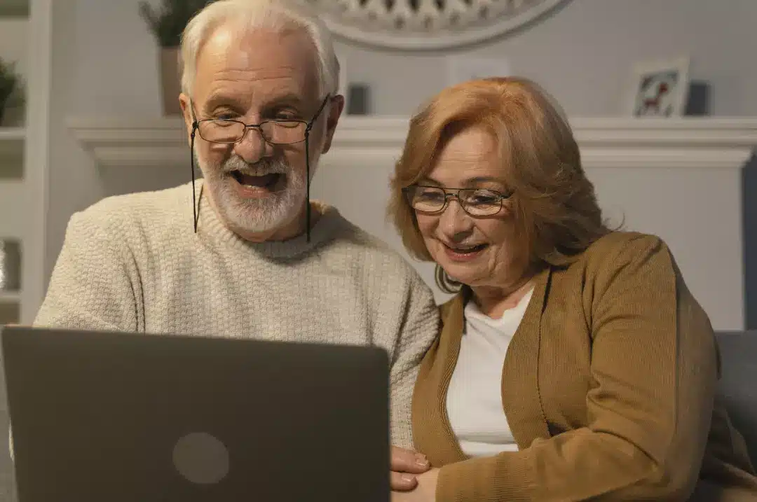 Senior couple using a laptop to research about the aged care sector in Australia.