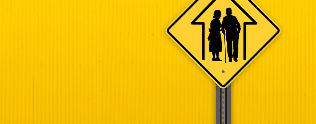 Road sign going to a nursing home with yellow background.