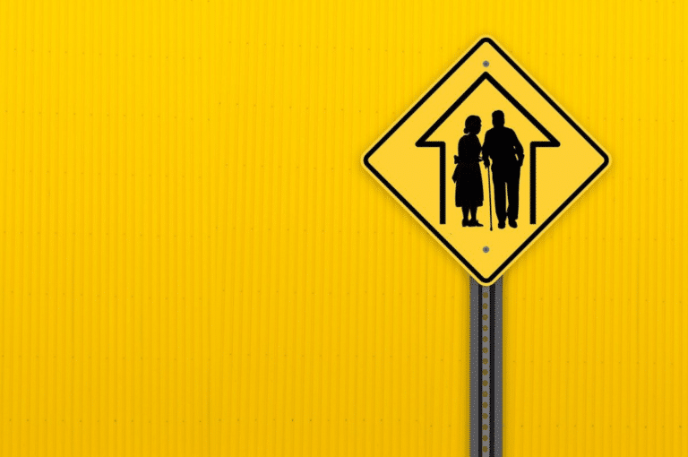 Road sign going to a nursing home with yellow background.