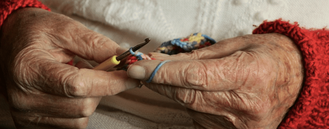 Old person doing a crochet.