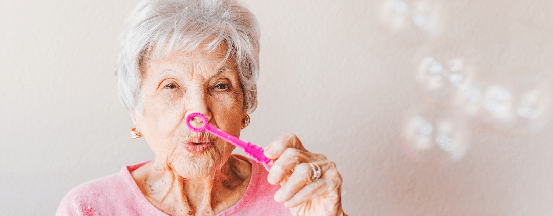 Old woman blowing bubbles.