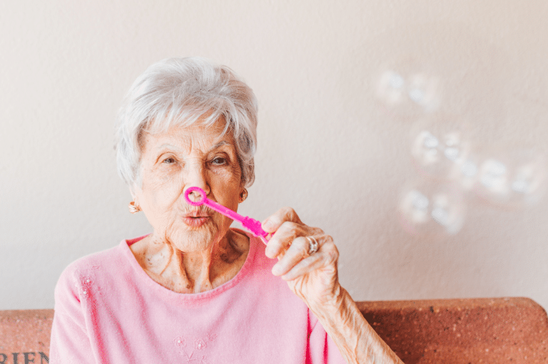 Old woman blowing bubbles.