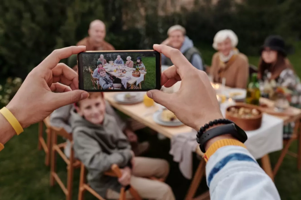 Taking a photo of a family dinner.