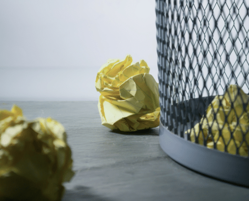 Yellow paper in the trash bin.