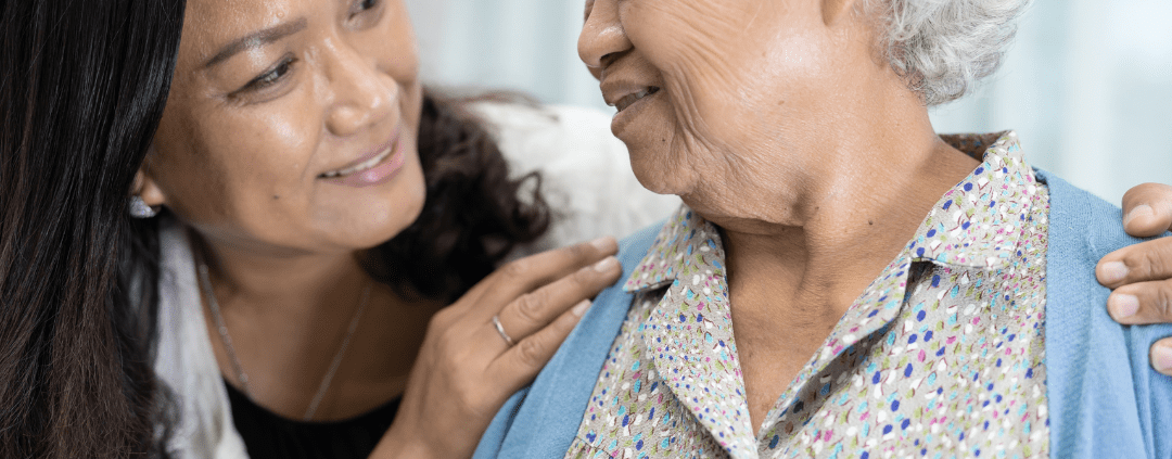 Happy senior woman looking at her carer.