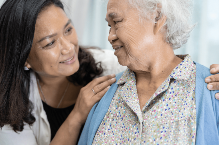 Happy senior woman looking at her carer.