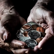 Old person holding coins.