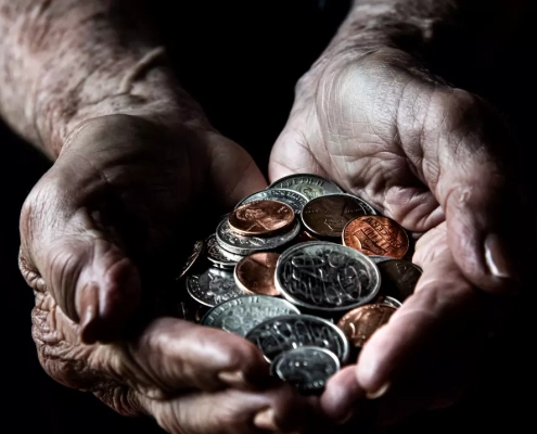 Old person holding coins.