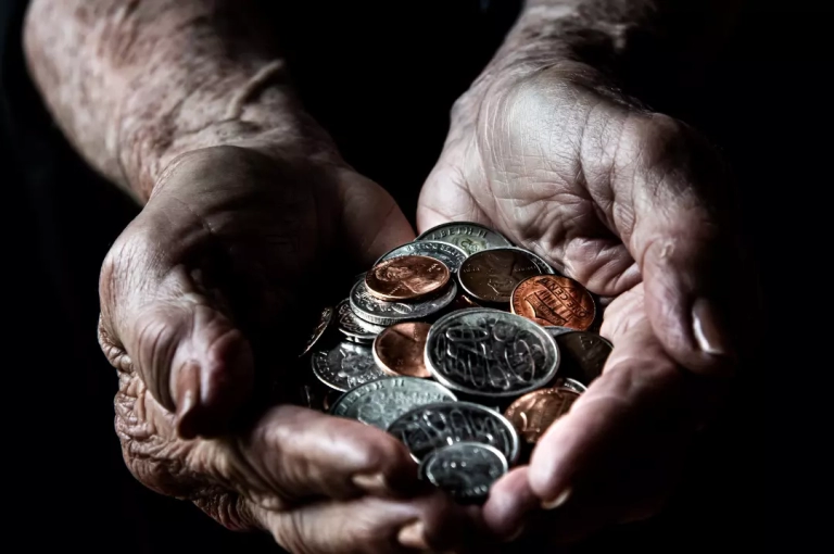 Old person holding coins.