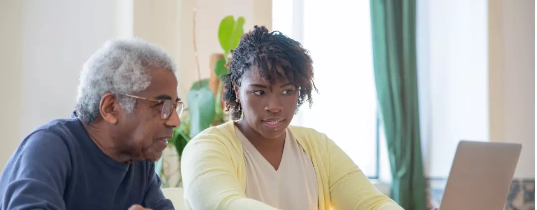 A carer discussing the respite care cost to an elderly.