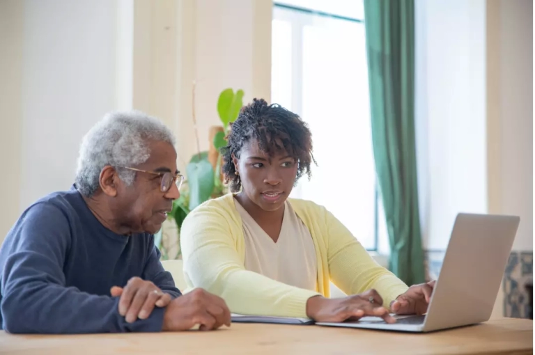 A carer discussing the respite care cost to an elderly.