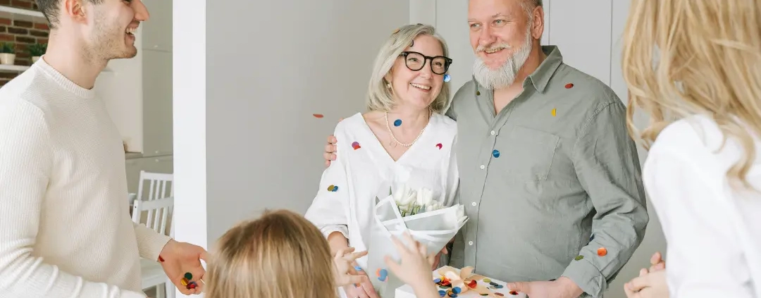 Children surprised elderly parents.