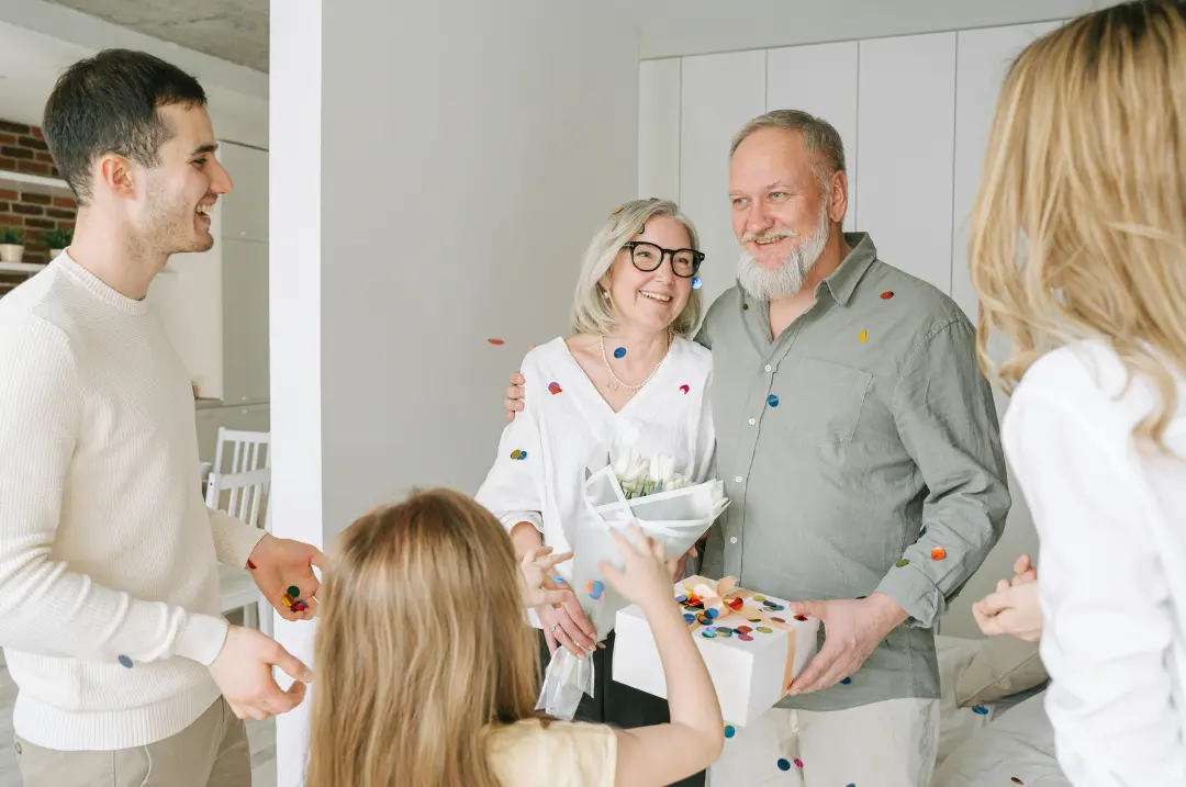 Children surprised elderly parents.