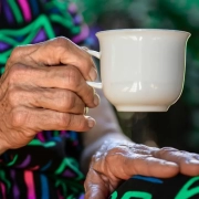 An old woman holding a cup.