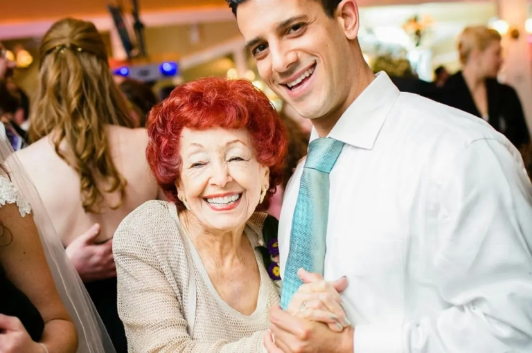 Old woman and a man dancing together.
